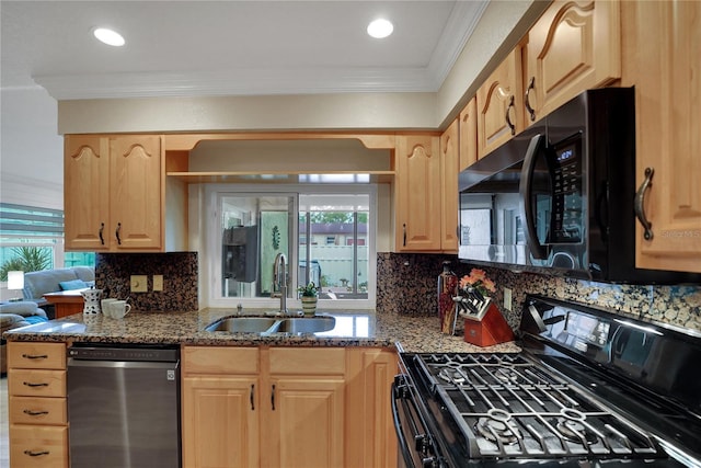 kitchen featuring dark stone counters, ornamental molding, black appliances, light brown cabinets, and a sink