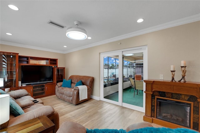 living room featuring ornamental molding, recessed lighting, visible vents, and wood finished floors