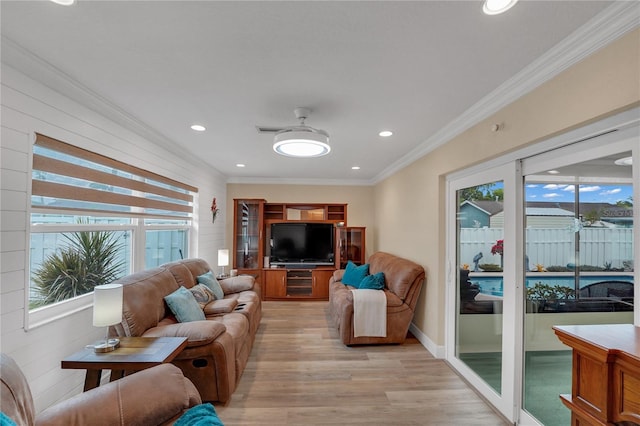 living area featuring light wood-style flooring, ornamental molding, a wealth of natural light, and recessed lighting