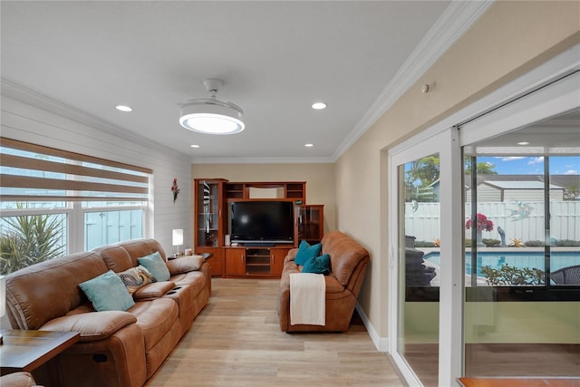 living area with light wood finished floors, recessed lighting, and crown molding