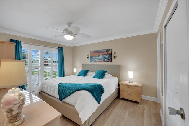 bedroom featuring baseboards, a ceiling fan, light wood-style flooring, crown molding, and a closet