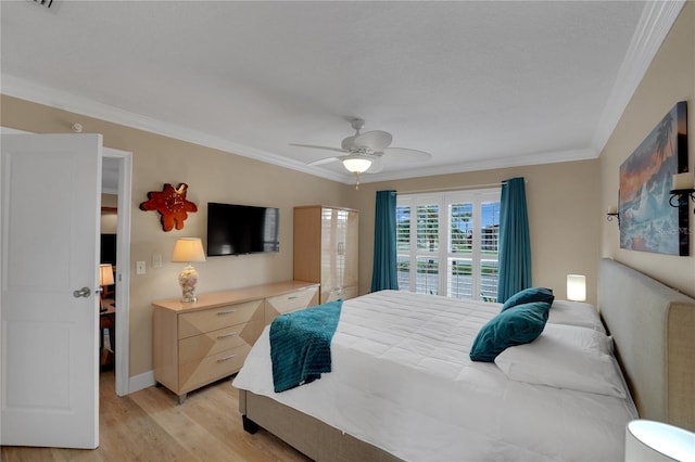 bedroom featuring baseboards, light wood-style flooring, ornamental molding, and a ceiling fan