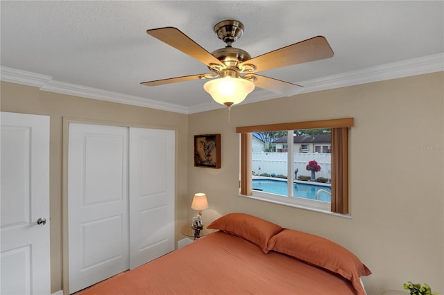 bedroom with ornamental molding, a closet, and ceiling fan