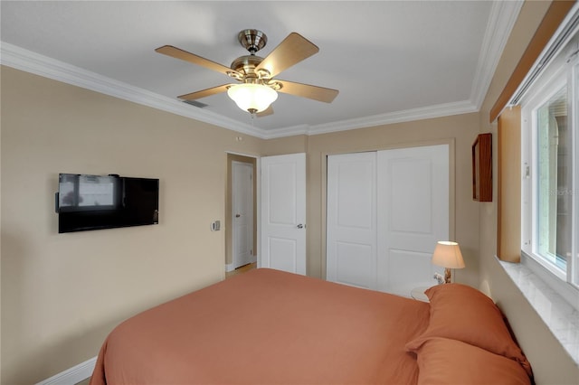 bedroom featuring a ceiling fan, a closet, visible vents, and crown molding