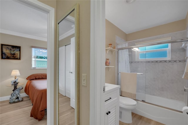 ensuite bathroom featuring crown molding, plenty of natural light, vanity, and wood finished floors