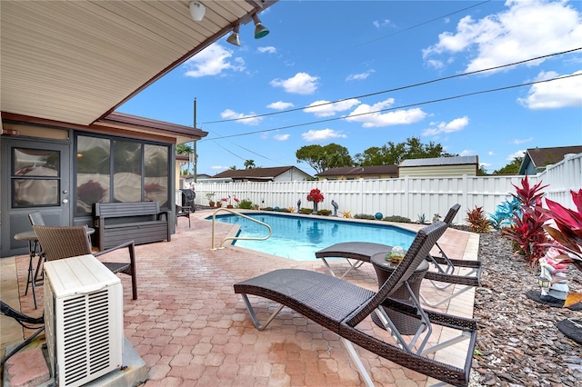 view of pool with ac unit, a patio area, a fenced backyard, and a fenced in pool