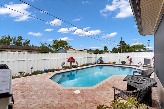 view of swimming pool featuring a fenced in pool, a fenced backyard, and a patio