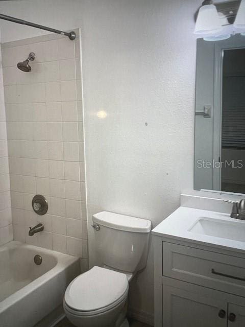 bathroom featuring shower / bath combination, vanity, and toilet