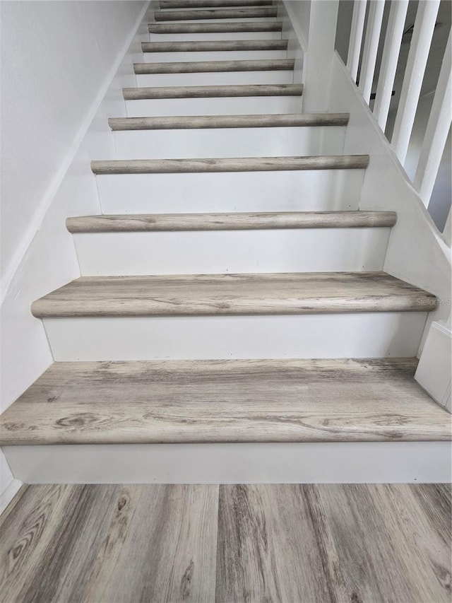 staircase featuring wood finished floors