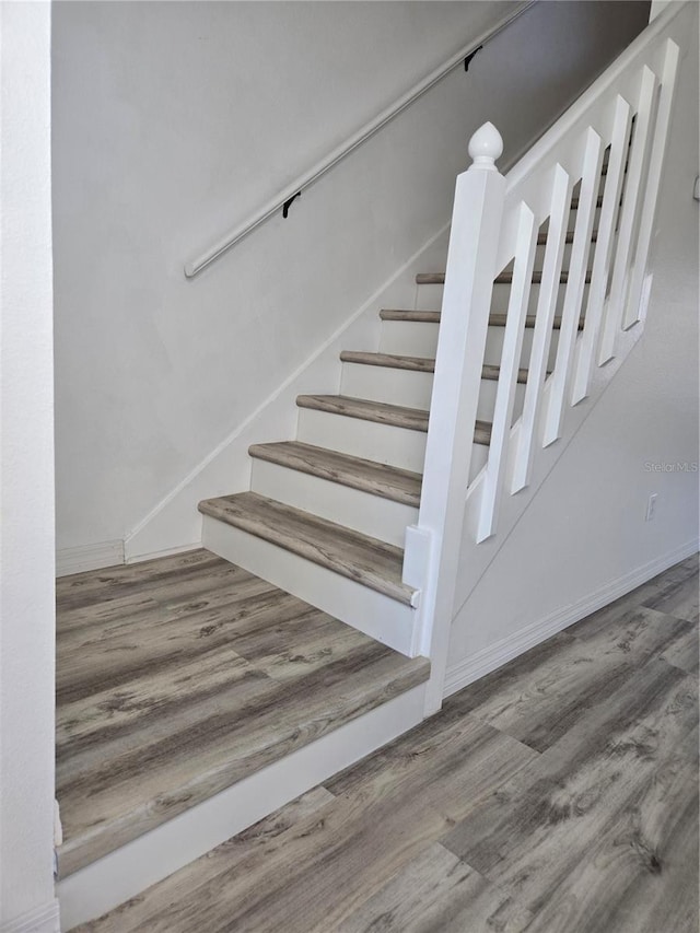 stairway with wood finished floors