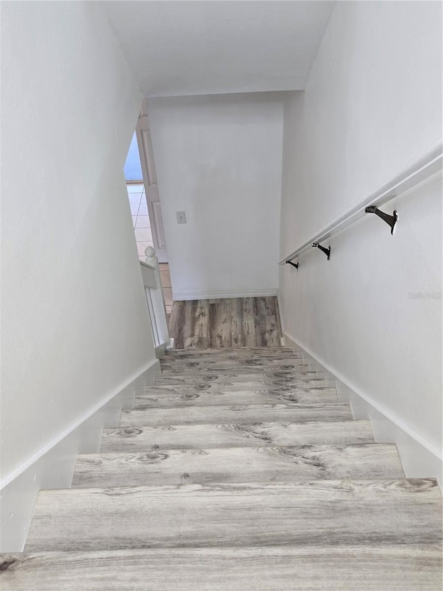 staircase with wood finished floors