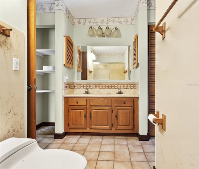 130 80th Ave NE, Saint Petersburg, FL 33702 - full bathroom featuring a sink, toilet, double vanity, and a stall shower