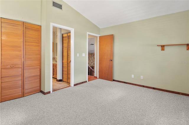 130 80th Ave NE, Saint Petersburg, FL 33702 - unfurnished bedroom with light carpet, visible vents, baseboards, and lofted ceiling