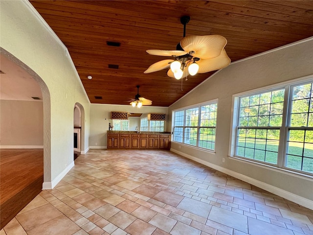 unfurnished sunroom with lofted ceiling, a fireplace, arched walkways, ceiling fan, and wooden ceiling