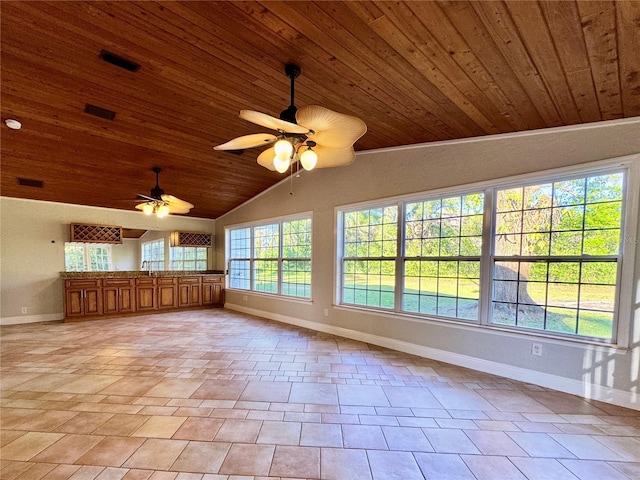 interior space with vaulted ceiling, light tile patterned floors, wood ceiling, and baseboards