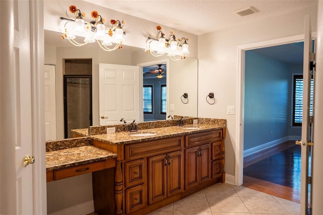 full bath featuring tile patterned flooring, double vanity, visible vents, and a sink