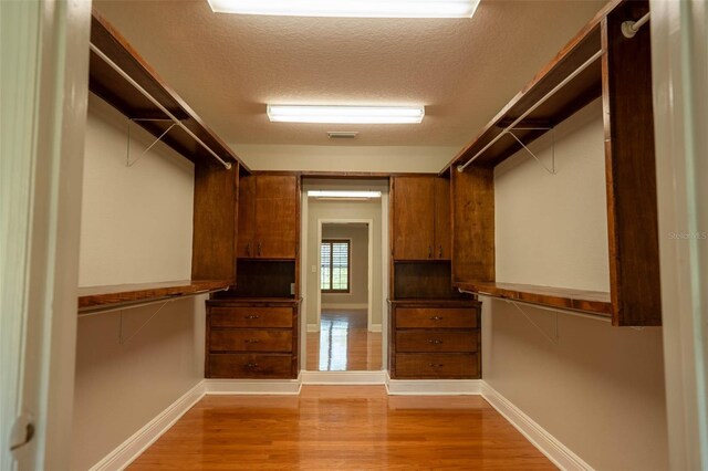 walk in closet featuring light wood-style floors