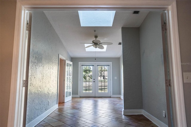 doorway to outside featuring french doors, baseboards, ceiling fan, and a textured wall