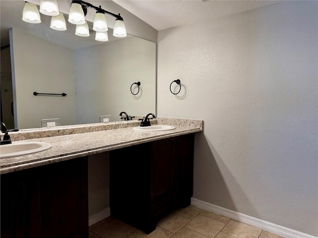 full bathroom featuring double vanity, baseboards, tile patterned floors, and a sink