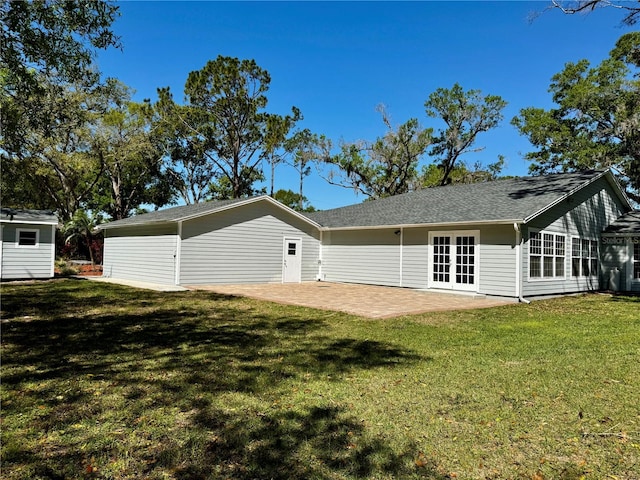 back of property with a patio, a yard, and french doors