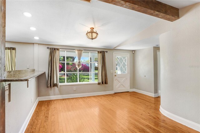 entryway featuring recessed lighting, beamed ceiling, baseboards, and light wood-style flooring