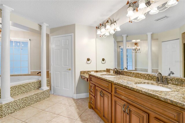 bathroom with a sink, decorative columns, visible vents, and tile patterned flooring