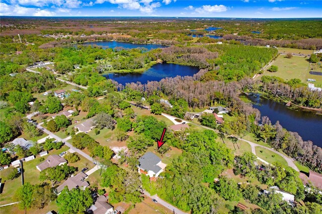 drone / aerial view featuring a water view and a view of trees