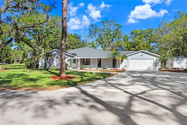 view of front of house with a garage, driveway, and a front yard