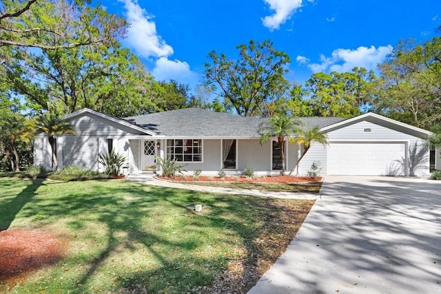 ranch-style home featuring a garage, driveway, and a front lawn