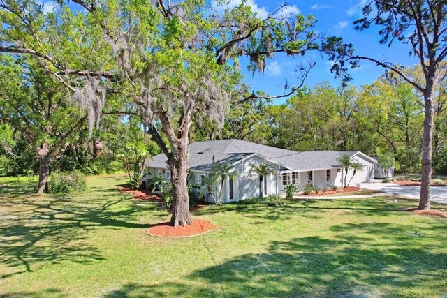 19531 Deer Lake Rd, Lutz, FL 33548 - single story home with a front yard, concrete driveway, and a garage
