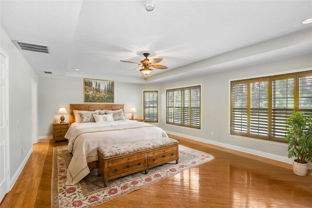 19531 Deer Lake Rd, Lutz, FL 33548 - bedroom with wood finished floors, baseboards, a raised ceiling, recessed lighting, and a ceiling fan