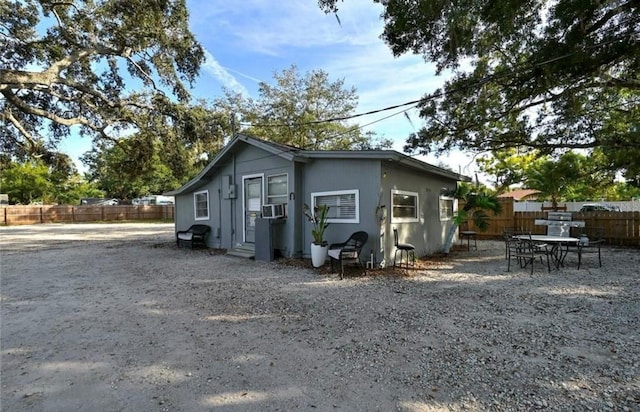 exterior space featuring fence and cooling unit