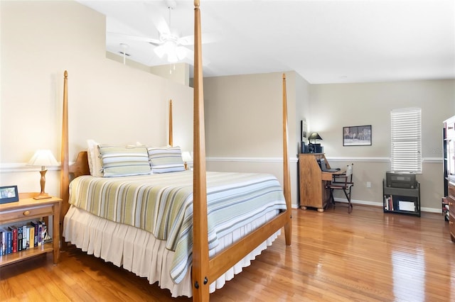 bedroom featuring wood finished floors and baseboards