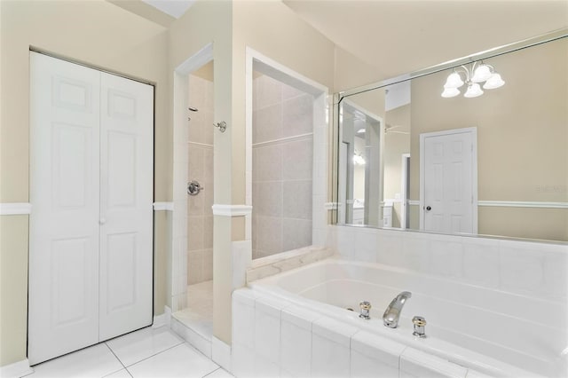 full bathroom featuring a tile shower, a closet, a garden tub, and tile patterned floors