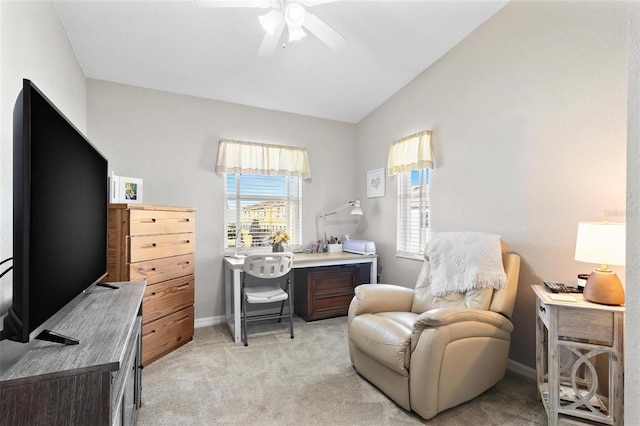 office featuring lofted ceiling, baseboards, a ceiling fan, and light colored carpet