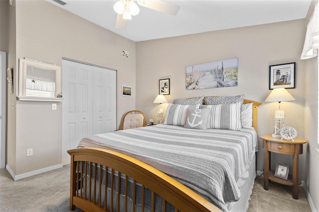 bedroom with light carpet, ceiling fan, baseboards, and a closet