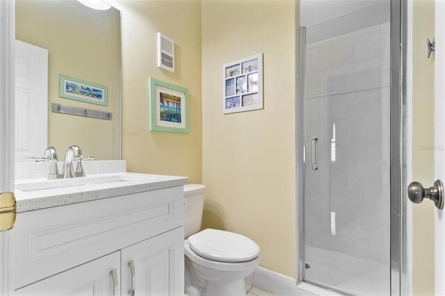 full bathroom featuring toilet, a shower stall, and vanity