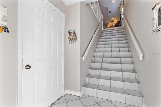 staircase with tile patterned flooring