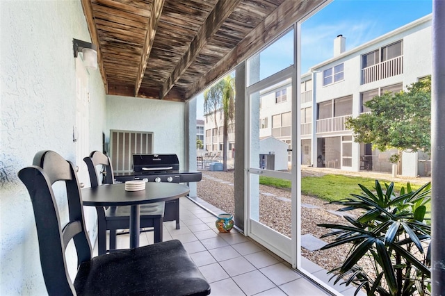 sunroom with wood ceiling and a residential view