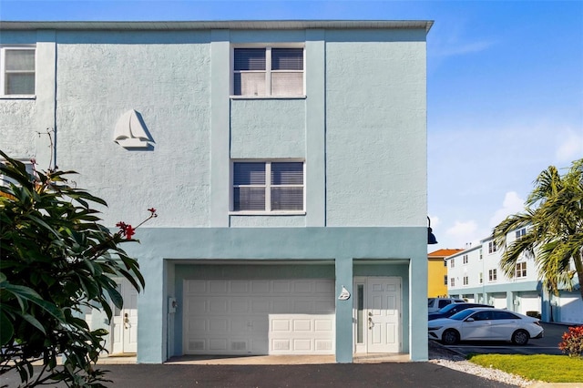 view of front of house featuring an attached garage and stucco siding