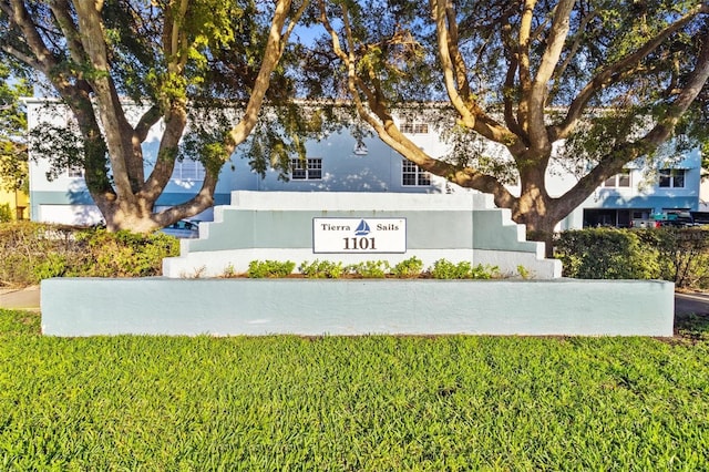 community / neighborhood sign with a lawn