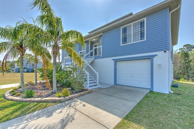 view of front of property with a front yard, stairway, covered porch, stucco siding, and a garage