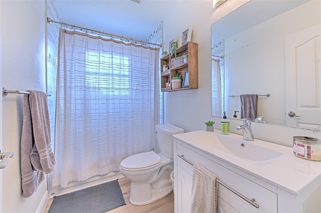 bathroom featuring vanity, toilet, wood finished floors, and shower / tub combo with curtain