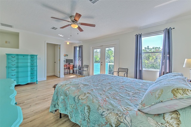 bedroom with access to exterior, visible vents, light wood finished floors, and french doors