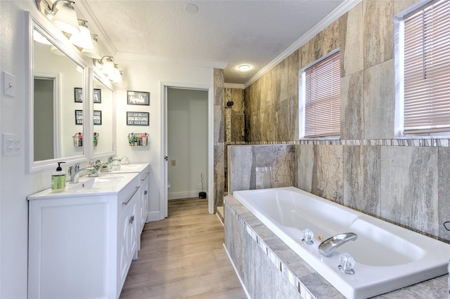 full bath featuring tiled shower, a garden tub, ornamental molding, and a textured ceiling