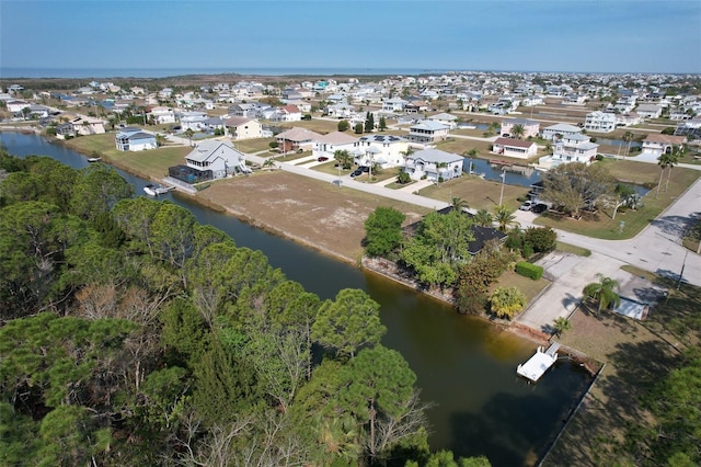 drone / aerial view featuring a residential view and a water view