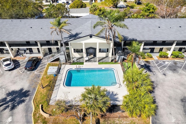 pool with fence and a patio