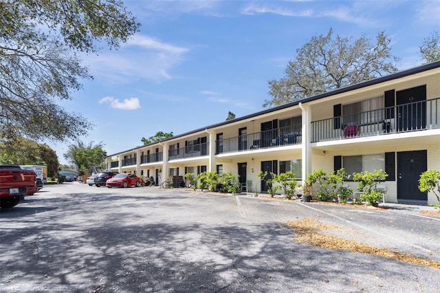 view of property featuring uncovered parking