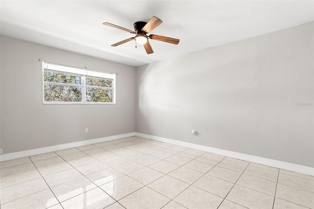 unfurnished room featuring a ceiling fan and baseboards