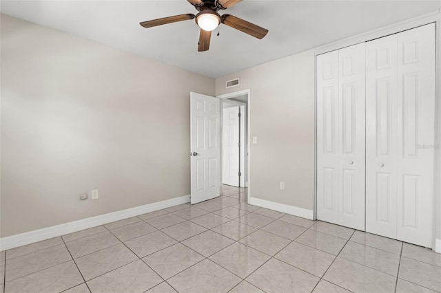 unfurnished bedroom featuring a closet, visible vents, baseboards, and light tile patterned flooring